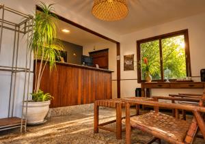 a waiting room with benches and a potted plant at Kastel Pedra Bonita in Petrópolis