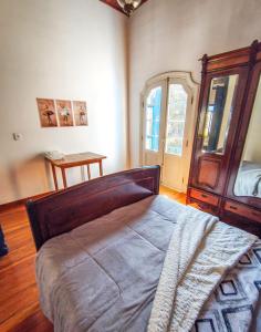 a bedroom with a large bed and a window at Refúgio Casarão in Passa Quatro