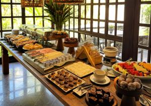 a buffet with many different types of food on a table at Kastel Pedra Bonita in Petrópolis