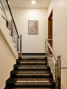 a set of stairs in a building with a picture on the wall at Hotel Brothers Kalka Highway in Panchkula +19 photos