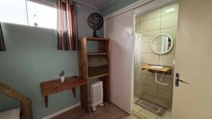 a bathroom with a sink and a ladder to a shower at Hostel Cape Town - Cambará do Sul in Cambará