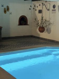 a swimming pool with a blue light in a room at Morada da Vovó Alda in Almeirim
