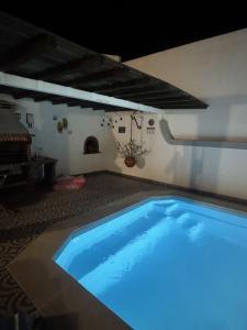 a large blue swimming pool in a house at Morada da Vovó Alda in Almeirim