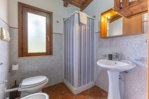 a bathroom with a toilet and a sink at Lemalu con giardino in Menfi +69 photos