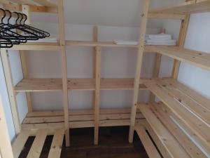 a closet with wooden shelves in a room at Anna-lak in Gyula