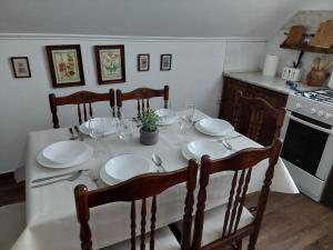 a dining room table with plates and glasses on it at Anna-lak in Gyula