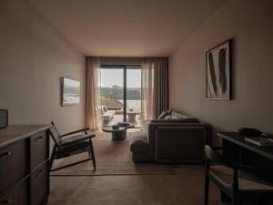 a living room with a couch and a chair at OKU Bodrum in Golturkbuku