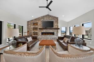 a living room with leather furniture and a fireplace at 238 Night Hawk Home in Granby