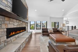 a living room with a large stone fireplace at 238 Night Hawk Home in Granby