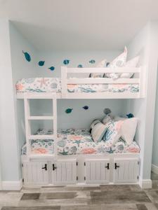 a white bunk bed in a childs bedroom at Blue Pearl Beachfront Condo at Casa de Mar in Galveston