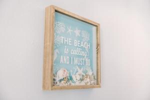 a framed picture of a beach is calling and i must go at Blue Pearl Beachfront Condo at Casa de Mar in Galveston +12 photos