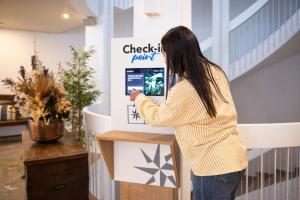 a woman is looking at a sign in a store at RVHotels Golf Costa Brava in Santa Cristina d'Aro +80 photos