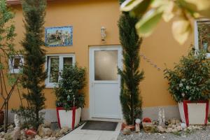 a house with christmas trees in front of a door at Cosy Tiny House Centro Vila Real in Vila Real