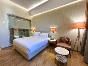 a hotel room with a bed and a chair at Hotel Imperial Blu in Similigurha +59 photos