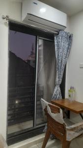 a room with a window with a table and a fan at Hotel Madhav Shankar in Rajkot +29 photos
