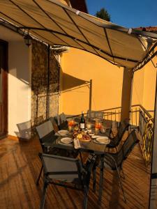 a table and chairs under a canopy on a patio at Casa Dani - terrazza relax, parcheggio gratuito e comfort a due passi da Oneglia in Imperia
