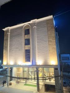 a building is lit up at night at Hotel Imperial Blu in Similigurha