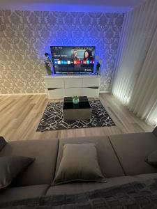 a living room with a couch and a flat screen tv at Apartamento As T3 Pombal in Pombal