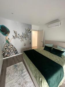 a bedroom with a bed and a wall with birds on it at Apartamento As T3 Pombal in Pombal +24 photos