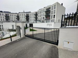 a gate in front of a building with buildings at Apartamento As T3 Pombal in Pombal