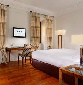 a hotel room with a bed and a desk at UNA Hotels Decò Roma in Rome +57 photos