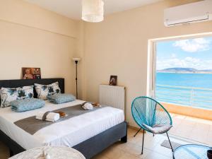 a bedroom with a bed and a large window at AB Preveza Apartments-15 Meters Over the Sea Attic & Alexander's the Great Executive Suite in Preveza