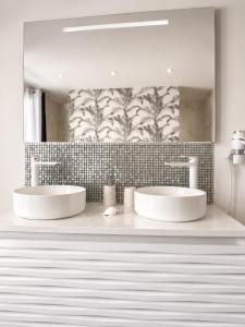 two sinks in a bathroom with a mirror at Maison "LA ROSALINDA-2B" Ghisonaccia in Ghisonaccia +90 photos