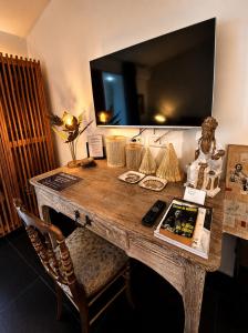 a wooden desk with a mirror on a wall at Maison "LA ROSALINDA-2B" Ghisonaccia in Ghisonaccia