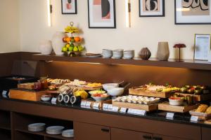 a buffet line with different types of food on display at Honest Budapest by chic&basic in Budapest