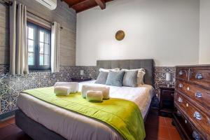 a bedroom with a large bed with a yellow blanket at Heated Saltwater Pool-Private Beachside Oasis in Mosteiros +56 photos
