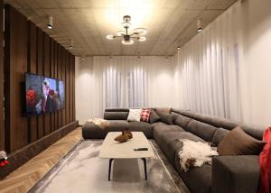 a living room with a couch and a tv at Montéa Villa in Brezovica