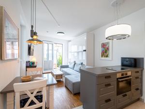 a kitchen and living room with a couch and a table at Quartier 7, App 06 in Ahlbeck