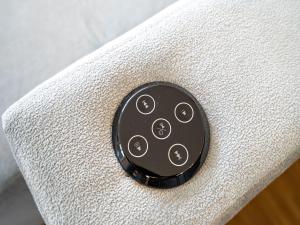 a black object sitting on top of a white couch at Quartier 7, App 06 in Ahlbeck
