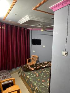 a bedroom with a bed and a table and chairs at Friends corner Dharamshala in Dharmsāla