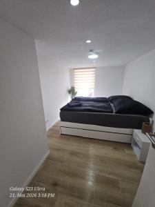 a bedroom with a bed in a white room at Schneiders Apartment Style House in Trunkelsberg +6 photos