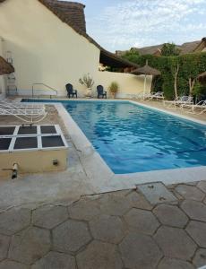 a swimming pool in front of a house at Coin du paradis in Saly Portudal