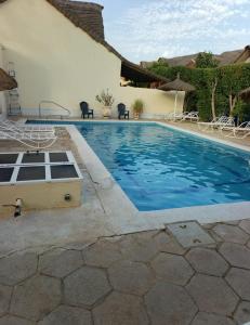 a swimming pool in front of a house at Coin du paradis in Saly Portudal