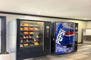 a vending machine with a bottle of soda at Delux Inn Mesquite Near I-30 Dallas in Mesquite