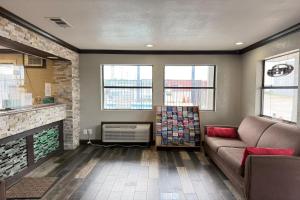 a living room with a couch and a fireplace at Delux Inn Mesquite Near I-30 Dallas in Mesquite