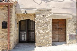 an entrance to a stone building with two doors at Loft 34 in Tarquinia