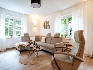a living room with a couch and a table at Ferienhaus Amica in Heringsdorf