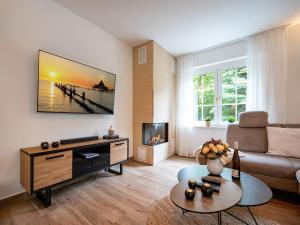 a living room with a couch and a table at Ferienhaus Amica in Heringsdorf