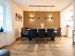 a dining room with a table and chairs at Ferienhaus Amica in Heringsdorf