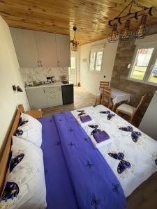 a bedroom with a large bed with purple sheets at Studio Apartman Tea, Žabljak in Žabljak +28 photos