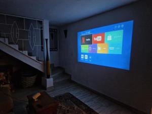 a living room with a large screen tv on the wall at Beach House in Saly Portudal