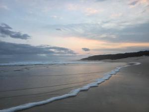 a view of a beach with the tide coming in at Kayser's Keep Self-Catering in Kayserʼs Beach