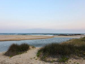 a sandy beach with the ocean in the background at Kayser's Keep Self-Catering in Kayserʼs Beach