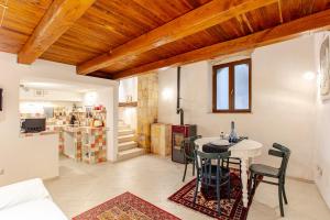 a room with a table and chairs and a kitchen at Loft 34 in Tarquinia