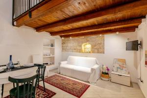 a living room with a white couch and a table at Loft 34 in Tarquinia