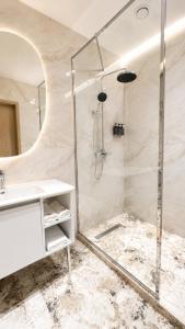 a bathroom with a shower and a sink at NOMAD Luxe Hotel in Zharkent +16 photos